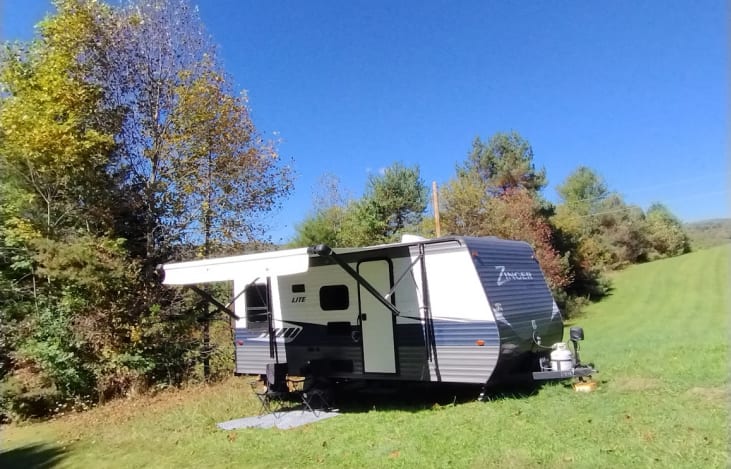 Side view of camper with awning