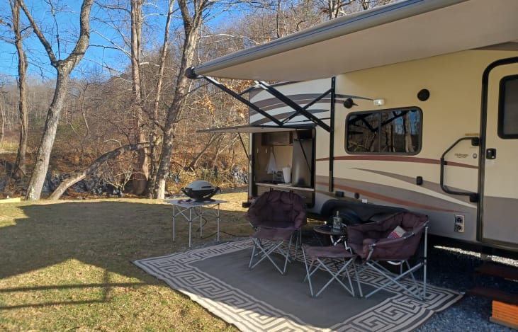 Outdoor comfort with large chairs, table and Electric Awning