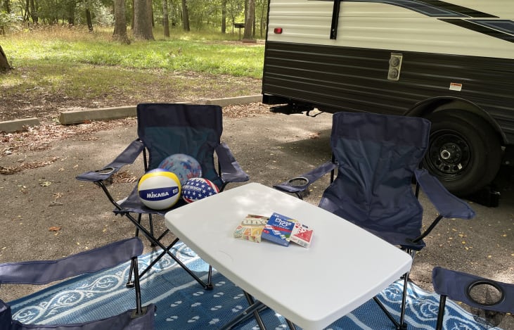 RV comes with 4 chairs, table, mat, and some games for the family!!