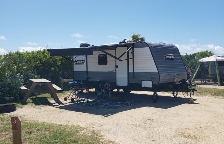 Camping at one of our favorite Florida State Parks, Gamble Rogers Memorial State Recreation Area. .You can also see our 4 camping chairs and Coleman Gas grill available