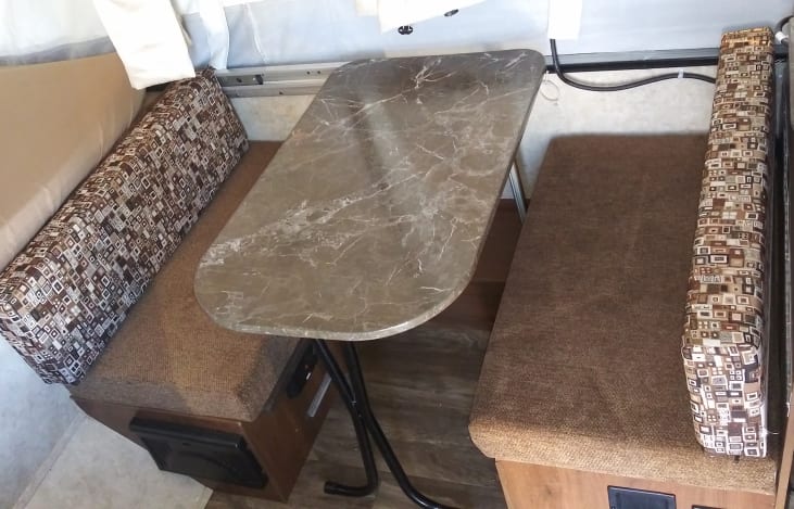 Dinner table that folds down to make a small bed for children.