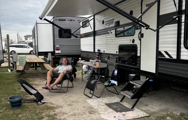 Motorized awning. Outdoor slide out flat top grill and mini fridge.
