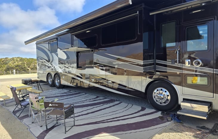 Outdoor setup with awning and rugs from another angle!