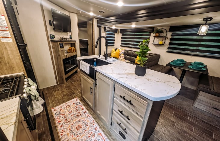 Spacious island with lots of counter/prep space, farmhouse sink and modern finishes.