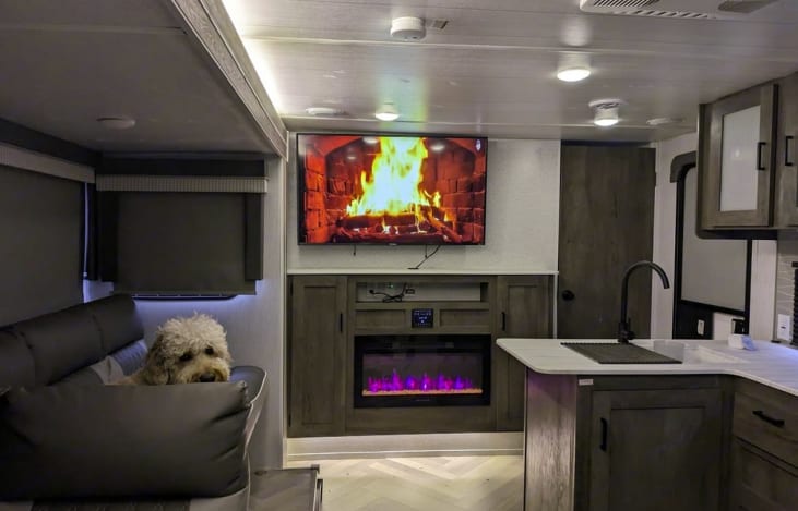 55inch 4k TV over an electric fireplace. in the living/dining space.