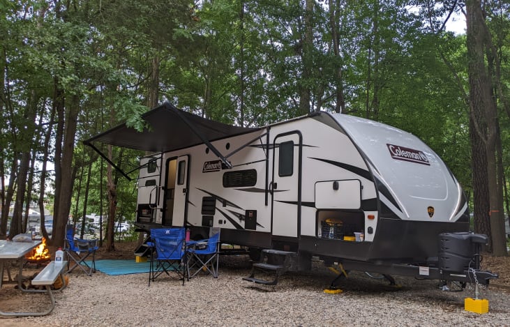 Lightweight (dry: 6200 lbs), with 2 external doors, a motorized slide-out, & a motorized awning with plenty of storage area. We also provide 4 chairs.
