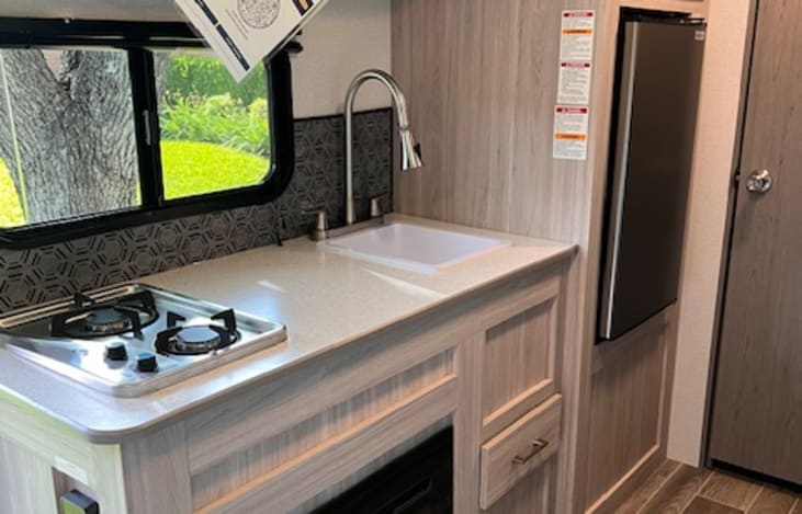 Cook top, sink, microwave, and fridge