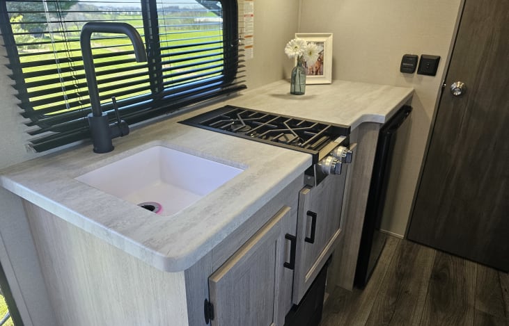 Kitchen area includes a toaster and Keurig coffee machine.