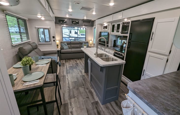Bright and modern kitchen, dining room and living room. Lots of big windows for a great view