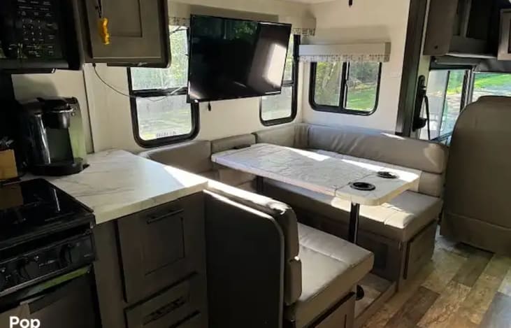 This table comes down and can be turned into a bed.  This is a smaller area so a larger adult would not fit.