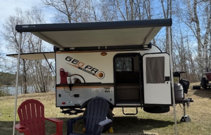 Driver's side with door, showing shelf with Keurig and there is also a place for a Blackstone