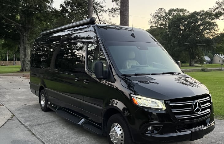 Motorized awning that can be extended for loading and unloading in wet conditions.