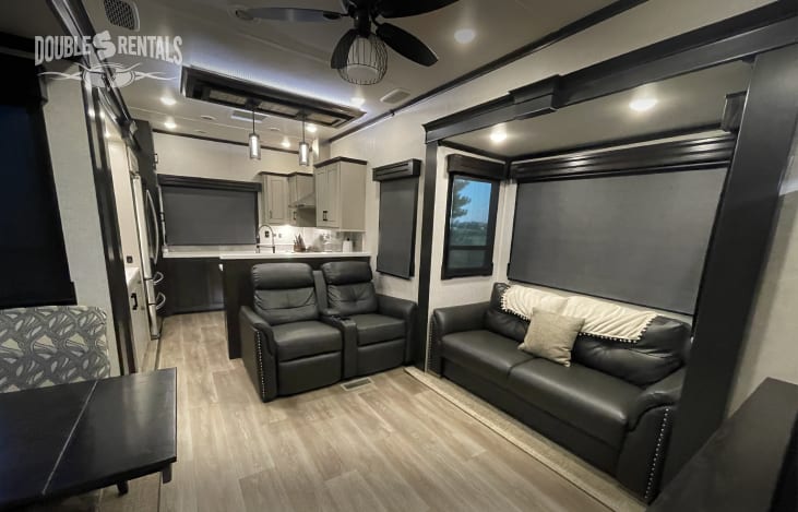 Living Area with Luxury Recliners and Pullout Sofa that Makes into Extra Sleeping Space