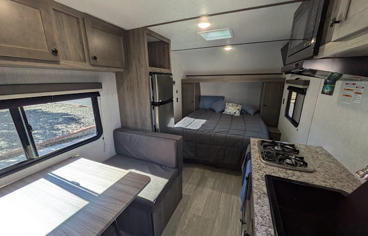 Spacious dinette, walk-around bed, galley kitchen and large bathroom.