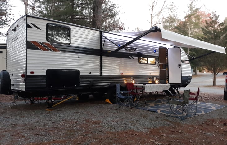 We set you up with a camp table, chairs, and rug.  The awning has an LED light strip.