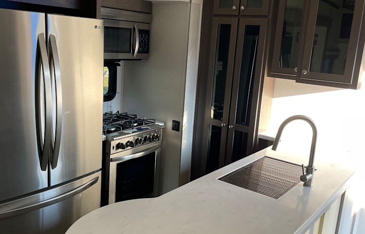 Full size oven, fridge, stove, microwave, and skink